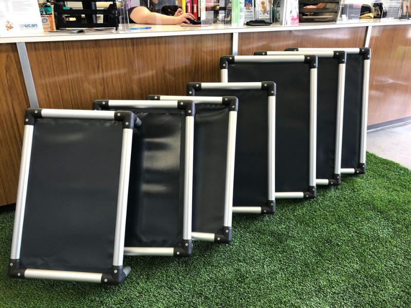 Donated Kuranda beds standing, stacked together.