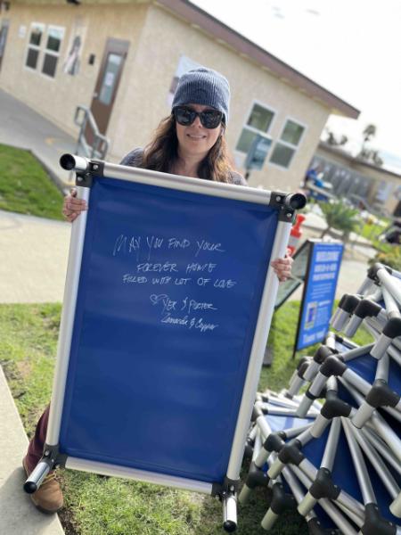 Volunteer holding up a Kuranda bed