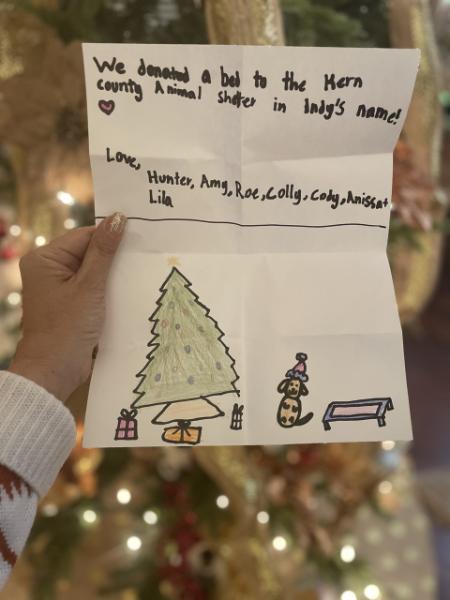 Teresa’s Christmas gift from family; an illustration created by granddaughter Monroe and note about the donation of a Kuranda bed to Kern County Animal Services in Indy’s name.